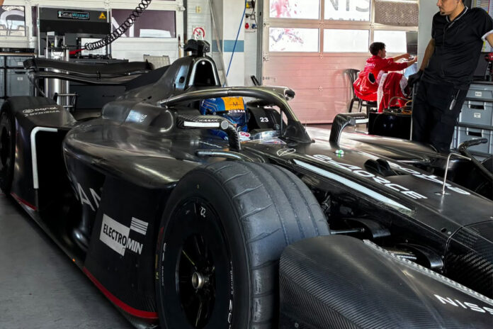 New team, new car, new tracks: Nissan Formula E Team’s Zane Ma Zane Maloney sitting in the Nissan Formula E Team GEN4 car in the garage with his blue and yellow helmet visible.